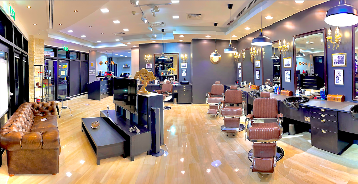 Barber finishing a sharp fade at James Pro Barbers
